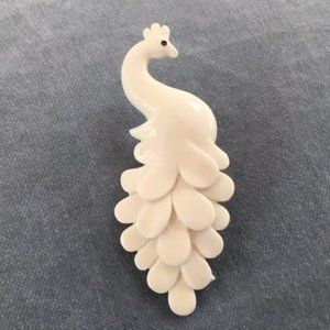 White plastic peacock pin